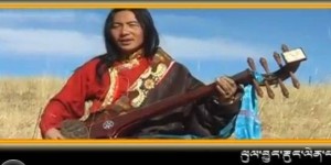 A video grab of Shawo Tashi playing dranyen in one of his music videos