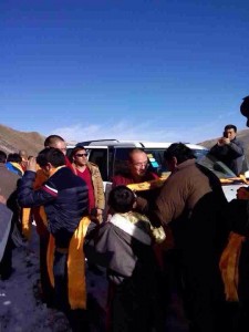 Local Tibetans welcome welcome Kunga Tsayang with ceremonial scarves.