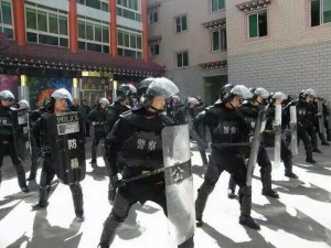 SWAT team with full riot gear performs drills to intimidate local Tibetans