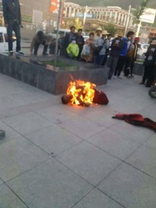 Passers-by look on as Sonam Topgyal stages self-immolation at Gesar Square