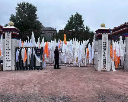 The gate of closed school adorned with khatags tied by teachers and students